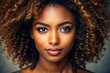 © Four888 - Vibrant close-up portrait of a stunning young black woman with luscious curly hair, warm skin, and bright brown eyes, exuding confidence and natural beauty.