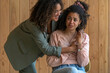© Connect Images - Two women share a comforting embrace, one offering support to the other who appears distressed.