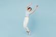 © ViDi Studio - Full body side view young woman wears striped t-shirt casual clothes leaning back raise up hands stand on toes dance isolated on plain pastel light blue background studio portrait. Lifestyle concept.
