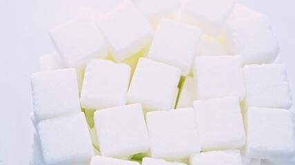 Poster - High angle view rotation of sugar lumpy close-up