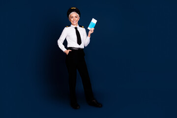 Poster - Full body photo of attractive senior woman passenger plane captain hold tickets dressed aviator uniform isolated on dark blue background