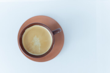 A warm cup of black coffee brewed by a home barista, surrounded by aromatic, freshly roasted Arabica coffee beans, creating a cozy and delicious morning break