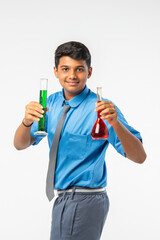 Indian Asian schoolboy conducting science experiment with chemicals in flask, isolated on white