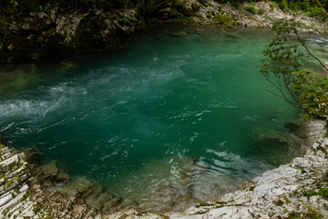 Vintgar Gorges Park a few km from Lake Bled, Slovenia. Wooden walkways accompany the path above the river rapids and waterfalls. River hits rocks and creates fog.Adventure family holidays. Freshness.