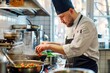 © Kevin - a man in a kitchen preparing food on a stove