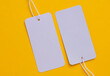 © splitov27 - Gray blank price tags on yellow background