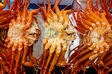 Sticker - Close up of stacked raw snow crabs with leg and belly for sale at a fish market of Jumunjin Port near Gangneung-si, South Korea
