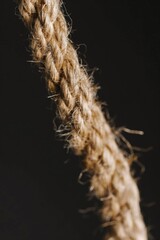 Poster - A close-up view of a rope on a dark, matte finish background