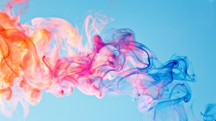 Poster - Vibrant colored smoke swirling in the air against a clear blue sky, creating an abstract artistic effect.