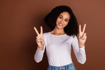 Poster - Photo of pretty young girl show v-sign wear pullover isolated on brown color background