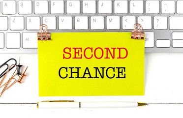Poster - SECOND CHANCE text on yellow sticky on keyboard