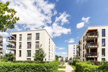 Wall Mural - Residential area with ecological and sustainable green residential buildings, low-energy houses with apartments and green courtyard