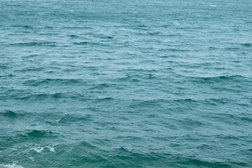 Sea water surface, wave texture. Calm seascape. The background of the blue waters of the sea. Background sea calm water.