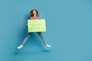 Sticker - Full length portrait of nice young girl happy womens day card jump wear top isolated on blue color background