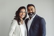 © CogniLens - Portrait of a happy indian couple in their 30s dressed in a stylish blazer isolated on blank studio backdrop