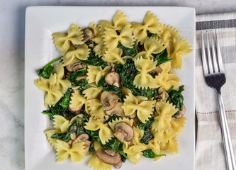 Wall Mural - farfalle pasta with  spinach and mushrooms