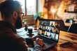 © Alina - Businessman using laptop and talking to his colleagues in video conference