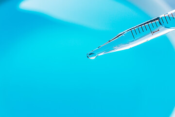 Wall Mural - water droplets macro science experiment,liquid drop from laboratory glass pipette