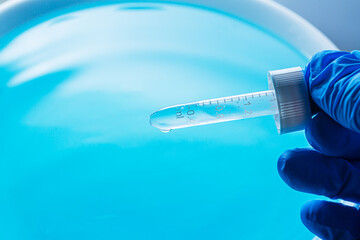 Wall Mural - water droplets macro science experiment,liquid drop from laboratory glass pipette