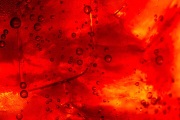 Wall Mural - macro cola background,Cola with Ice. Close up of the ice cubes in cola water. Texture of carbonate drink with bubbles in glass. Cola soda and ice splashing fizzing or floating up to top of