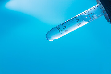 Wall Mural - water droplets macro science experiment,liquid drop from laboratory glass pipette