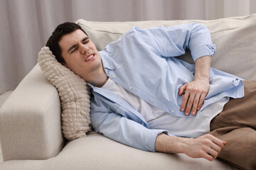 Canvas Print - Man suffering from abdominal pain at home