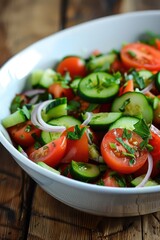 Poster - A bowl of salad with tomatoes, cucumbers, and onions. The bowl is on a wooden table