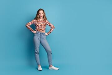 Sticker - Full length portrait of nice young girl hands waist empty space wear top isolated on blue color background