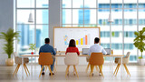 Modern office interior with three colleagues working collaboratively on a project with a city view