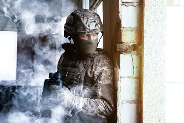 Wall Mural - Soldier with binoculars inside building during military operation