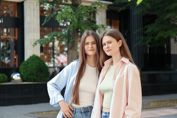 Canvas Print - Portrait of two beautiful twin sisters outdoors