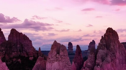 Wall Mural - the rocky pinnacles seem to be reaching for the sky their sharp peaks sc against the cotton candy cl