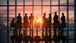 © umitcanc.stock - Professional meeting in modern office silhouettes against vibrant sunset backdrop, reflecting collaborative atmosphere