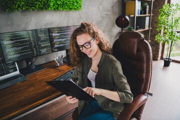 Photo of lovely confident successful woman software developer sitting armchair comfortable workspace workstation indoors