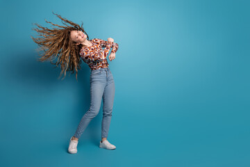 Sticker - Full size photo of nice young girl dancing partying wear top isolated on blue color background