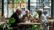 © liliyabatyrova - Three older people are sitting at a table in a restaurant, laughing