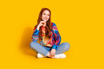 Canvas Print - Full length photo of lovely young lady sit floor crossed legs minded dressed stylish colorful garment isolated on orange color background