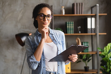 Poster - Photo of minded successful lovely woman wearing trendy jeans clothes holding resume document modern office workspace indoors