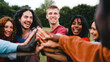 © Vane Nunes - Team stacking hands in circle. Group of friends celebrating together at park city. Support, collaboration and win concept