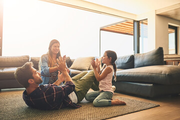 Poster - Clapping, playing and family with game in home for bonding together on floor for child development. Weekend, happy and girl kid having fun with parents on carpet in living room at house in Canada.