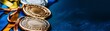 © JM_GUERRERO - Three medals are displayed on a blue background