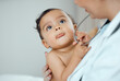 © KayJoint/peopleimages.com - Pediatrician, consultation and baby in hospital for healthcare, development and support for growth. Doctor or woman, child and talking or discussion in clinic for wellness, exam and trust for expert