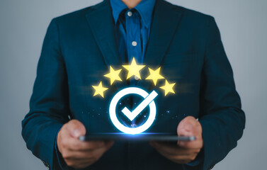 Poster - Businessman holding tablet and showing the best quality assurance with golden five stars for guarantee product and ISO service concept.