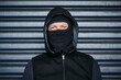 © Chanelle2000/peopleimages.com - Dark background, thief or man in portrait with mask, identity protection and face hide for crime mission. Outdoor, male criminal and disguise for theft, robbery and illegal activity for burglar