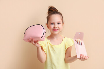 Sticker - Cute little girl with cosmetic bag and makeup brushes on brown background