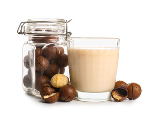 Wall Mural - Glass of fresh macadamia milk and jar with nuts on white background