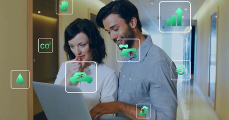 Poster - Image of ecology icons over diverse colleagues using laptop in office