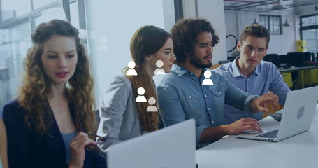 Poster - Image of media icons over diverse colleagues using laptop in office