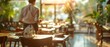 © vanilnilnilla - Blurred view of worker cleaning tables at restaurant with copy space