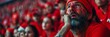 © Elmira - A dejected football fan wearing a red jersey and painted face, looks up in disappointment as he reacts to his team's loss at a stadium filled with other red-clad fans